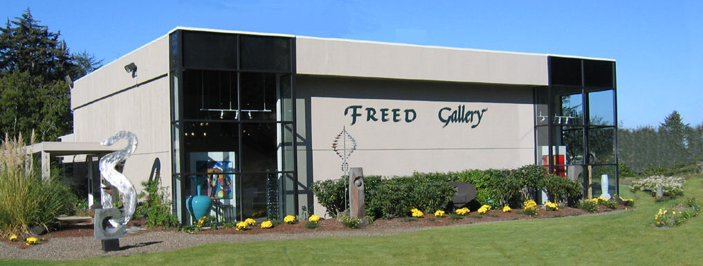 Exterior view of an Oregon Coast art gallery showcasing sculptures and fine art by Northwest and international artists.