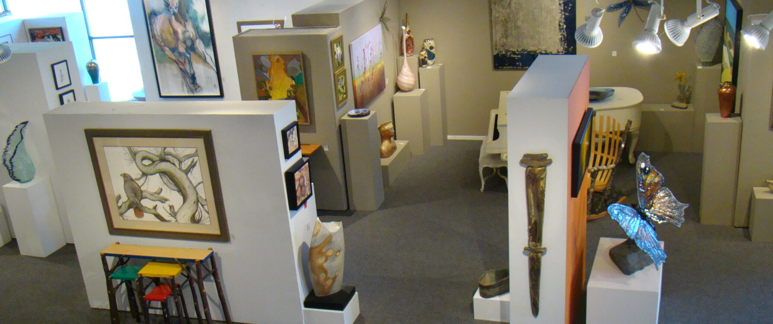 Art gallery with sculptures, paintings by Northwest and international artists, showcasing fine art and exhibitions on the Oregon Coast.